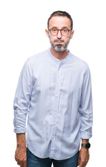 Middle age hoary senior man wearing glasses over isolated background puffing cheeks with funny...