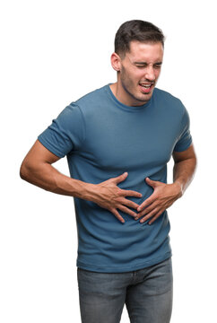 Handsome young casual man with hand on stomach because indigestion, painful illness feeling unwell. Ache concept.