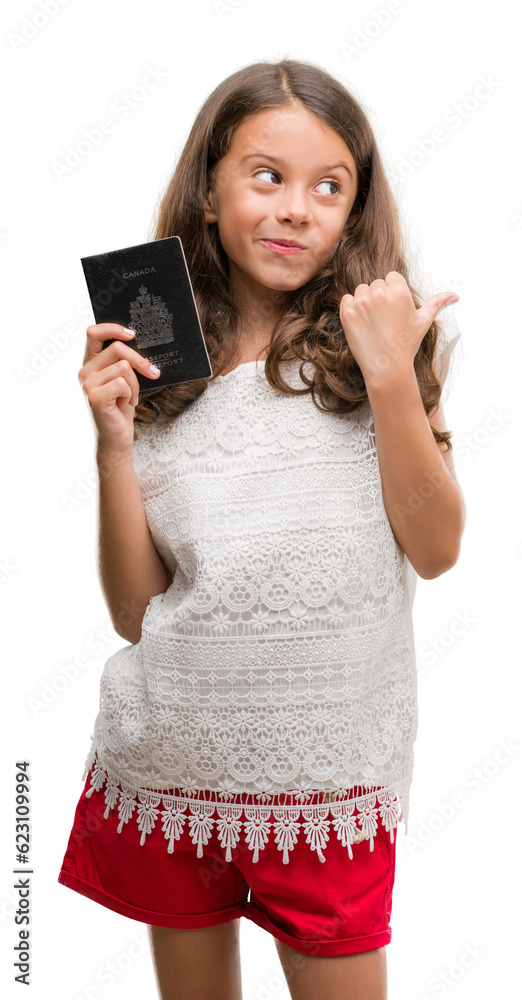 Poster brunette hispanic girl holding passport of canada pointing and showing with thumb up to the side wit