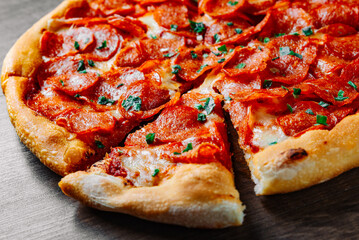Pepperoni Pizza with Mozzarella cheese, salami, Tomato sauce, pepper, Spices. Italian pizza on wooden table background