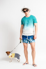 Man in hat, sunglasses and beach outfit with Jack Russell Terrier dog