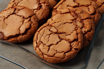 Crunchy homemade cookies on glass plate on gray background