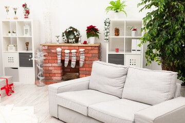 Bright room with white walls decorated with Christmas ornaments
