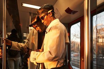 Attractive multiracial men enjoying company of each other while riding in public transport