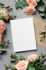 Wedding invitation card mockup with envelope, fresh eucalyptus and roses flowers