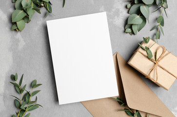 Greeting card mockup with gift box, envelope and eucalyptus plant