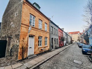 Fototapeta na wymiar Copenhagen, Denmark - March 23, 2022: beautiful colored facades of houses in the center of Copenhagen