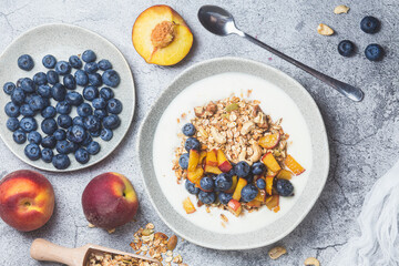 Granola with yogurt, peach, blueberries in a plate 