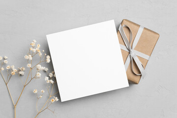 Square card mockup with gift box and dry gypsophila flowers