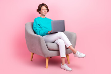 Fototapeta na wymiar Full length photo of lovely young lady sit armchair work smm manager marketer wear trendy blue garment isolated on pink color background