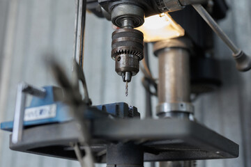 Tapping tool in spindle tapping into a hole in steel plate