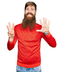 Redhead man with long beard wearing casual clothes showing and pointing up with fingers number eight while smiling confident and happy.