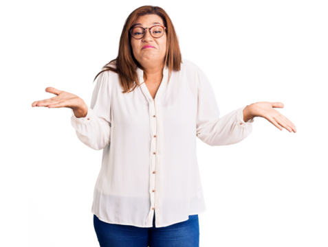 Middle age latin woman wearing casual clothes and glasses clueless and confused expression with arms and hands raised. doubt concept.