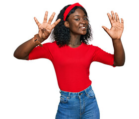 Beautiful african young woman wearing casual clothes showing and pointing up with fingers number...