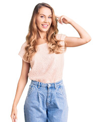 Fototapeta premium Young beautiful caucasian woman with blond hair wearing casual clothes smiling pointing to head with one finger, great idea or thought, good memory