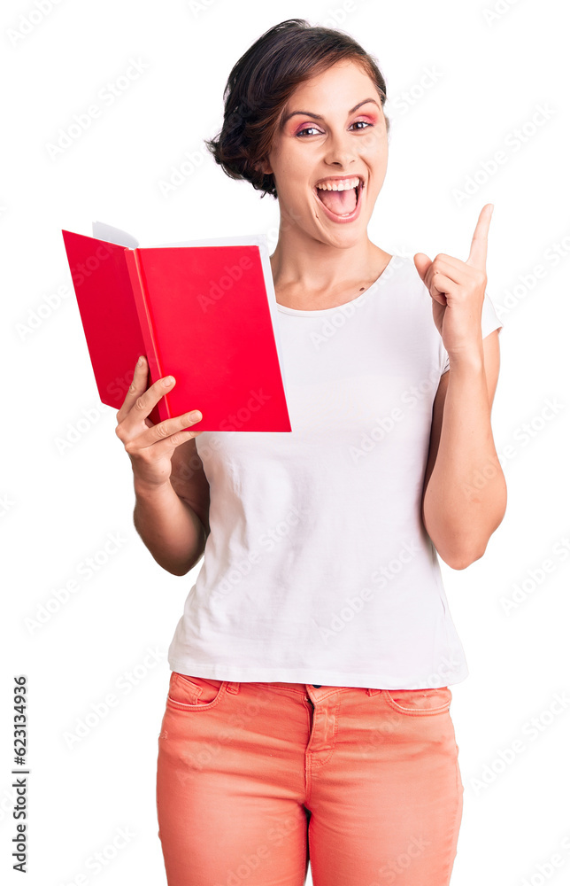 Sticker Beautiful young woman with short hair reading a book surprised with an idea or question pointing finger with happy face, number one