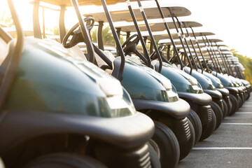 Many golf carts for golf player on a golf course. golf course carts cars at luxury resort sport...