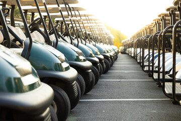 Many golf carts for golf player on a golf course. golf course carts cars at luxury resort sport...