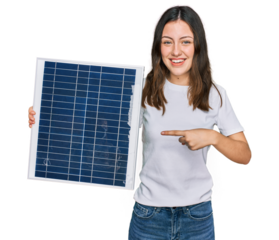 Young beautiful girl holding photovoltaic solar panel smiling happy pointing with hand and finger