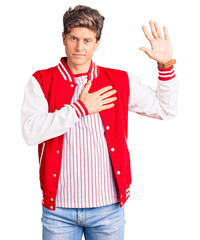 Young handsome man wearing baseball uniform swearing with hand on chest and open palm, making a...