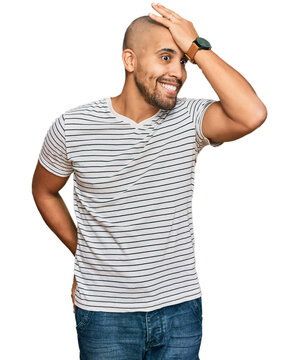 Hispanic adult man wearing casual clothes surprised with hand on head for mistake, remember error. forgot, bad memory concept.