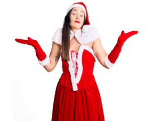 Young beautiful caucasian woman wearing santa claus costume clueless and confused expression with arms and hands raised. doubt concept.