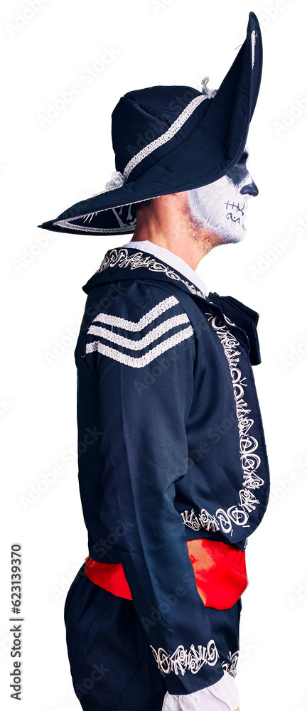 Canvas Prints Young man wearing day of the dead costume over background looking to side, relax profile pose with natural face with confident smile.