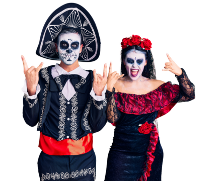 Young couple wearing mexican day of the dead costume over background shouting with crazy expression doing rock symbol with hands up. music star. heavy music concept. - Powered by Adobe