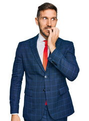 Handsome man with beard wearing business suit and tie looking stressed and nervous with hands on...