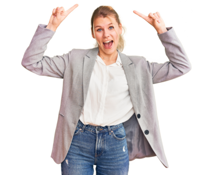 Young beautiful blonde woman wearing elegant jacket smiling amazed and surprised and pointing up with fingers and raised arms.