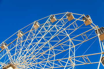 Fragment of Ferris wheel against the sky