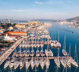 Amazing panoramic view of the picturesque town of Trogir in Croatia, with promenades and piers with boats at the coast at the Adriatic Sea - obrazy, fototapety, plakaty