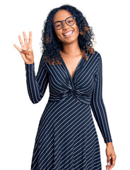 Young african american woman wearing casual clothes and glasses showing and pointing up with...