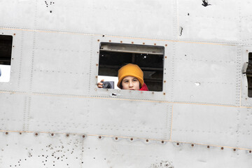 Girl with her camera in the window of the plane that crashed on a beach in Iceland