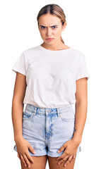 Young beautiful blonde woman wearing casual white tshirt skeptic and nervous, frowning upset because of problem. negative person.