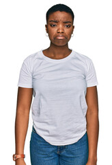 Fototapeta premium Young african american woman wearing casual white t shirt depressed and worry for distress, crying angry and afraid. sad expression.