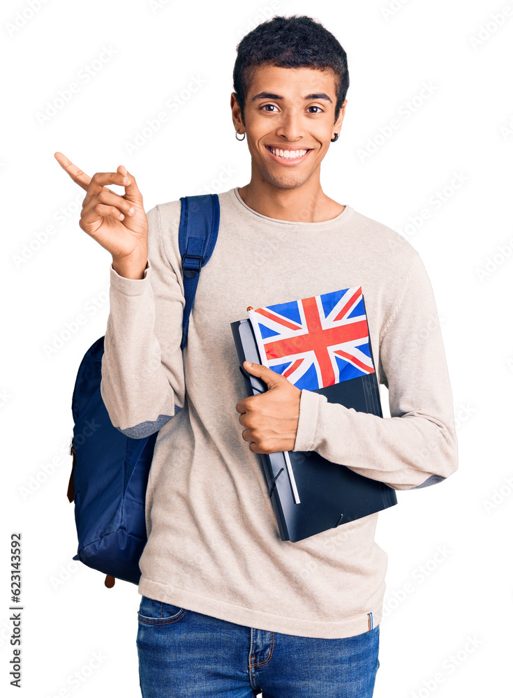 Sticker Young african amercian man wearing student backpack holding binder and uk flag smiling happy pointing with hand and finger to the side