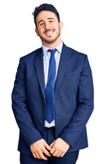 Young hispanic man wearing business clothes looking positive and happy standing and smiling with a confident smile showing teeth