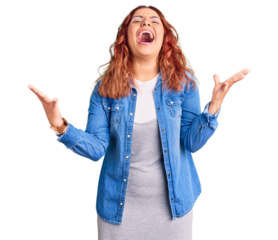 Young latin woman wearing casual clothes crazy and mad shouting and yelling with aggressive expression and arms raised. frustration concept.