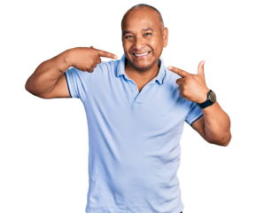 Hispanic middle age man wearing casual t shirt smiling cheerful showing and pointing with fingers teeth and mouth. dental health concept.