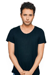 Fototapeta premium Young handsome man wearing casual black t shirt depressed and worry for distress, crying angry and afraid. sad expression.