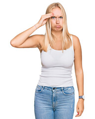 Fototapeta premium Young blonde girl wearing casual style with sleeveless shirt worried and stressed about a problem with hand on forehead, nervous and anxious for crisis