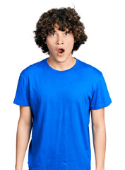 Fototapeta premium Caucasian teenager wearing casual clothes afraid and shocked with surprise expression, fear and excited face.