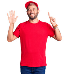 Naklejka premium Young handsome blond man wearing t-shirt and cap showing and pointing up with fingers number six while smiling confident and happy.