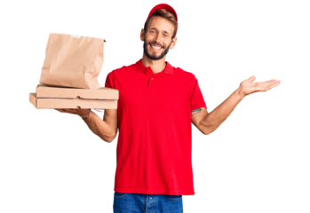 Handsome blond man with beard holding take away food celebrating victory with happy smile and winner expression with raised hands