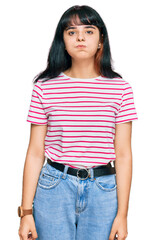 Obraz premium Young hispanic girl wearing casual clothes puffing cheeks with funny face. mouth inflated with air, crazy expression.