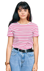 Obraz premium Young hispanic girl wearing casual clothes looking sleepy and tired, exhausted for fatigue and hangover, lazy eyes in the morning.