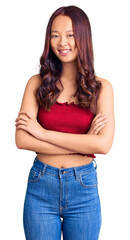 Young beautiful chinese girl wearing casual clothes happy face smiling with crossed arms looking at the camera. positive person.