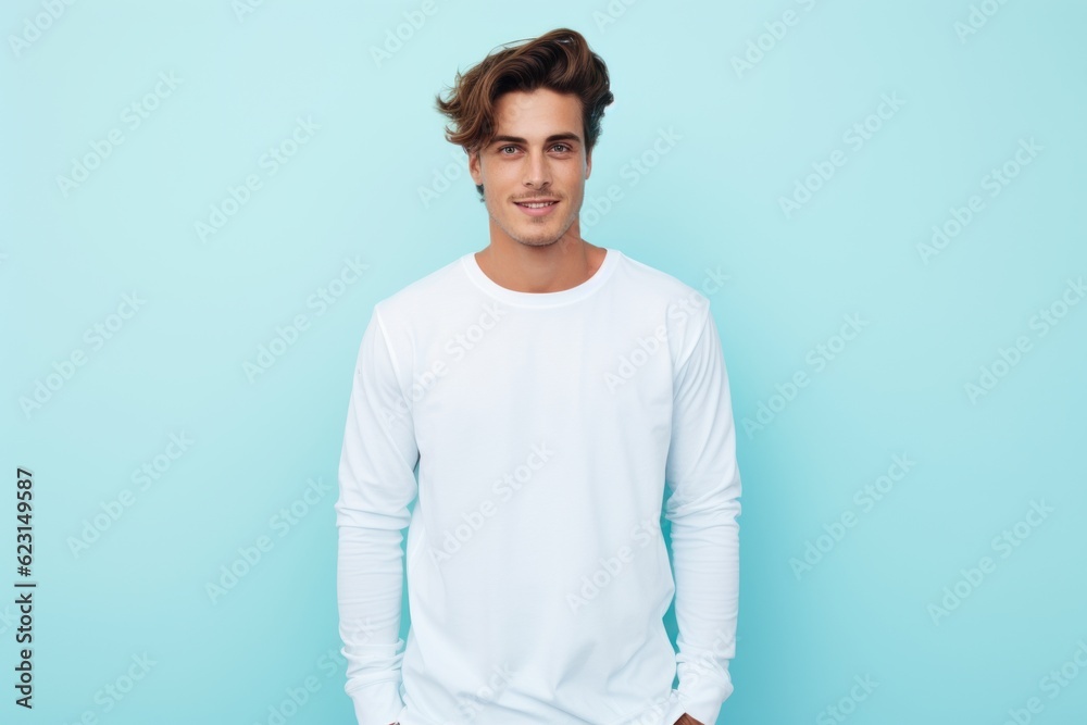 Wall mural a photo of a handsome fit model guy with a blank white canvas long sleeve shirt. pastel blue wall background. Generative AI