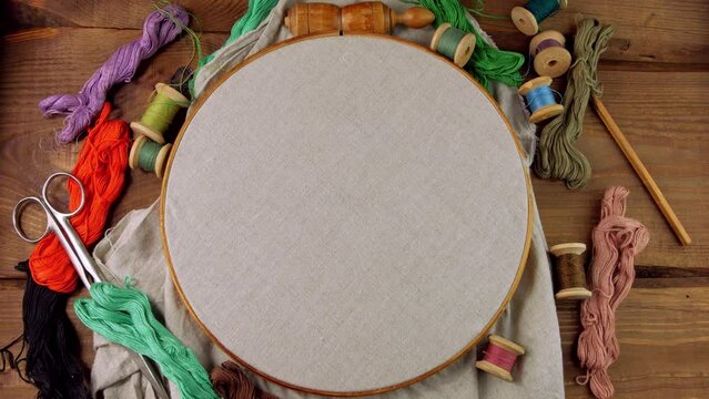 Embroidery needlework background Linen in hoop mockup. Colorful floss thread scissors card tag. Handmade ethnic style clothes making home decor tablecloth. New normal lockdown hobby crafts tutorial.